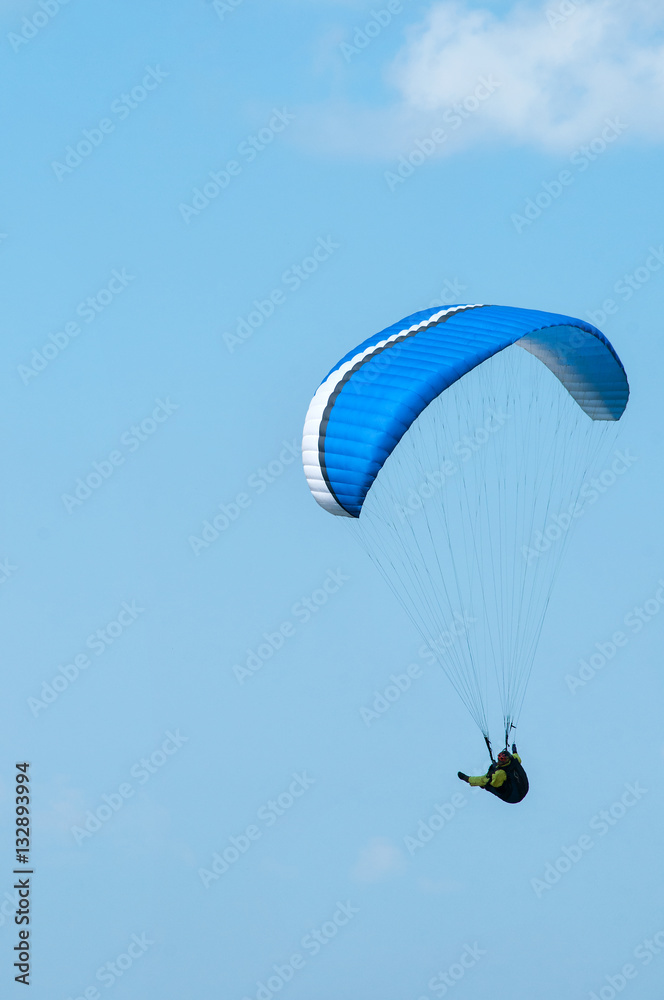 Paraglider flying in the sky on a paraglider. Paragliding. Paraglider flying in the sky on a paraglider. Paragliding.