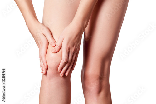 Closeup view of a young woman with knee pain. isolated on white background. 