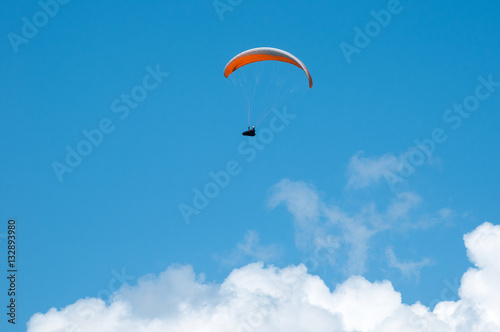 Paraglider flying in the sky on a paraglider. Paragliding.