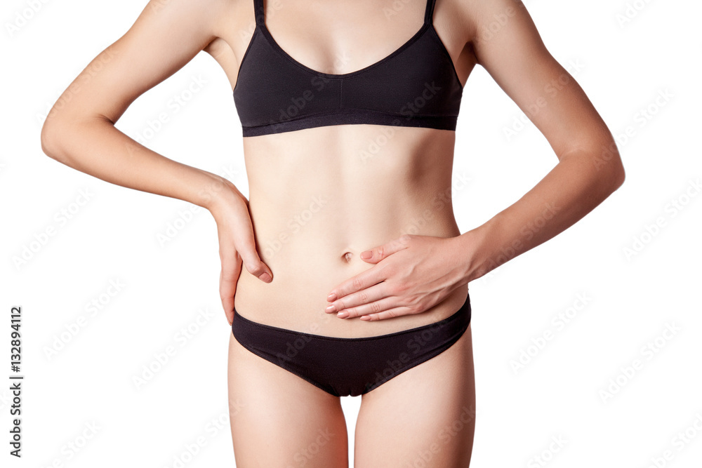 Closeup view of a young woman with stomach pain or digestion or period cycle . isolated on white background.
