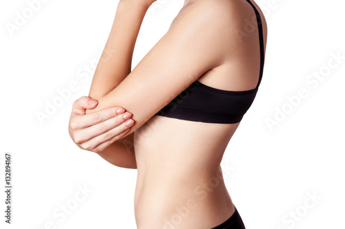 Closeup view of a young woman with elbow pain. isolated on white background. 