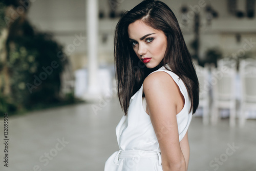 Beautiful, glamour, sexy model in white dress posing at hotel. © anatoliycherkas