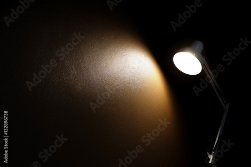 light from the lamp on the wall