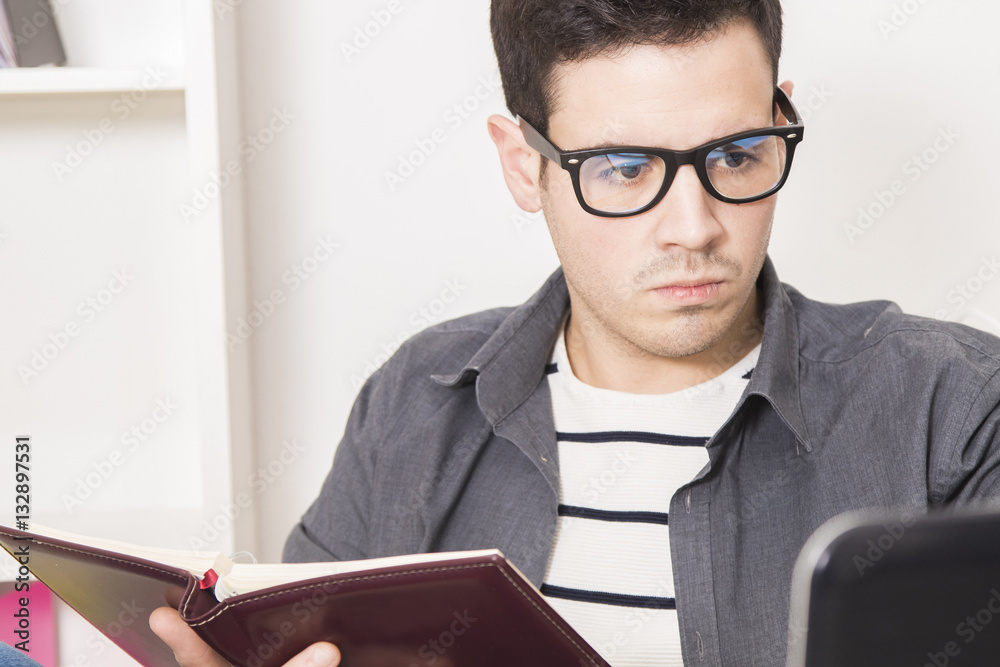 young freelance with the agenda and the computer laptop young freelance with the agenda and the computer laptop
