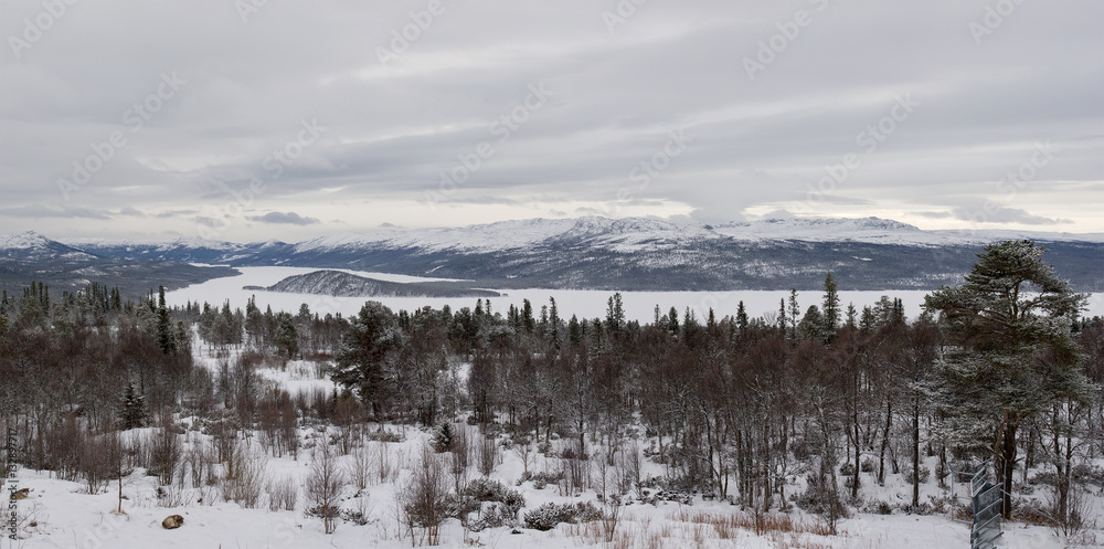 Panoramic view of winter landscape with rocks and frozen lake