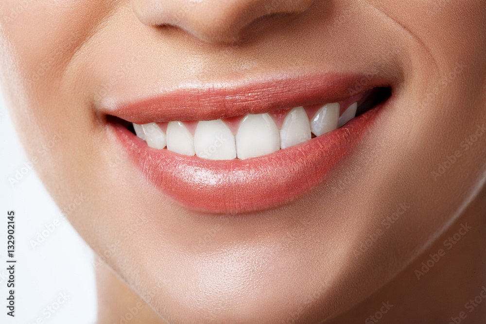 Fototapeta premium Close up of beautiful wide smile of young fresh woman with great healthy white teeth. Isolated over white background