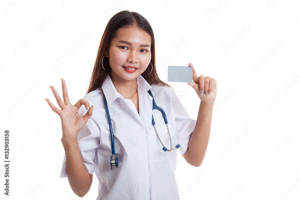 Asian young female doctor show Ok sign with blank card. Asian young female doctor show Ok sign with blank card.