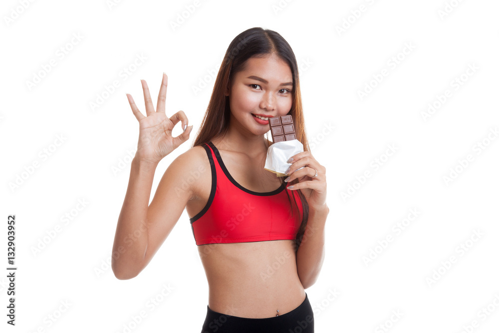 Beautiful healthy Asian girl show OK with chocolate. Beautiful healthy Asian girl show OK with chocolate.