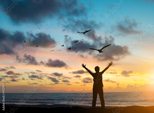 silhouette prisoners were imprisoned on the island alone, praying and free bird fly over blurred nature sunset background. hope and people concept and international day of peace.