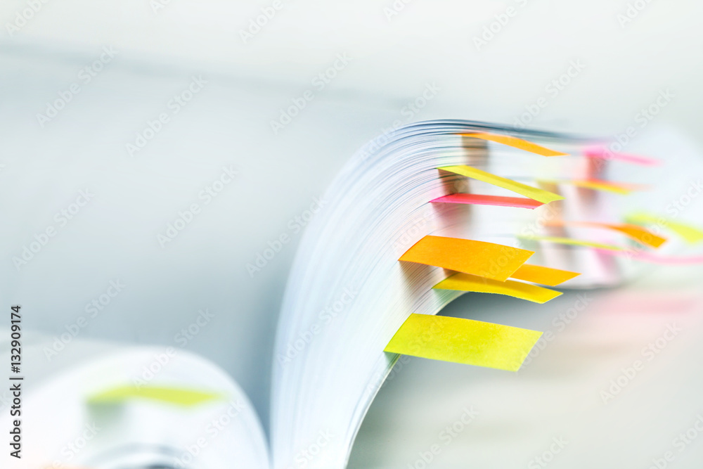 Fototapeta premium Close up White book marked by sticky note