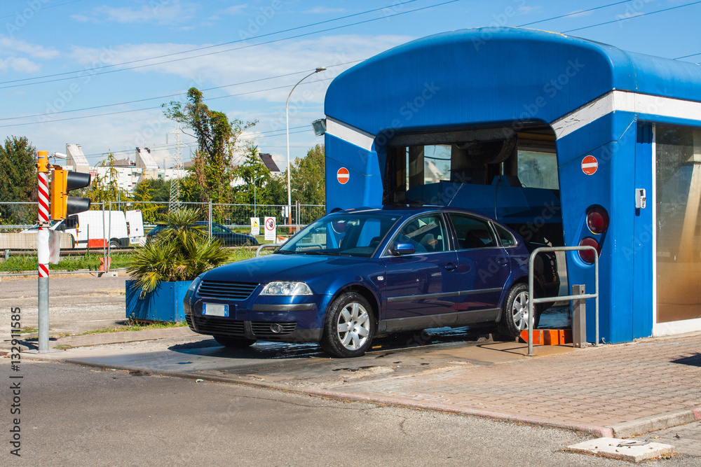 Automated portal carwash with a car running through.