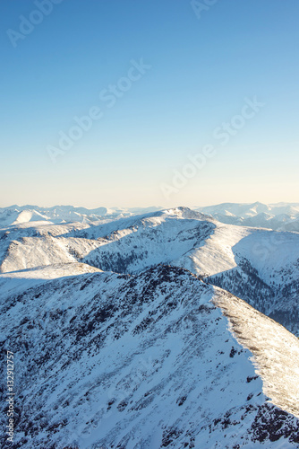 majestic winter landscape of snowy mountains with clear blue sky