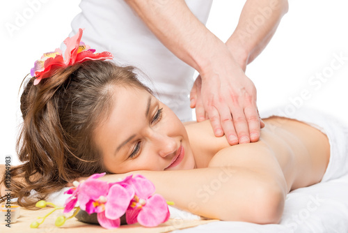 Serene woman enjoying a massage or skin treatment in the spa