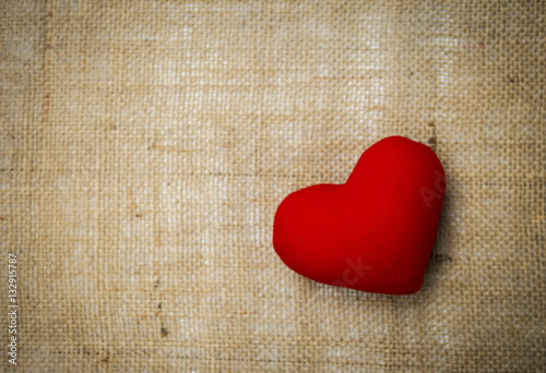 Red heart on hessian texture background, valentine background