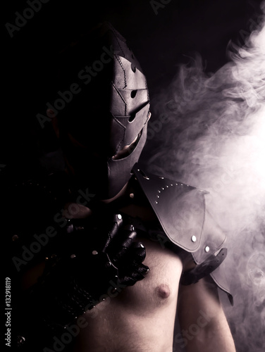 warrior in mask in abstract smoke on black background