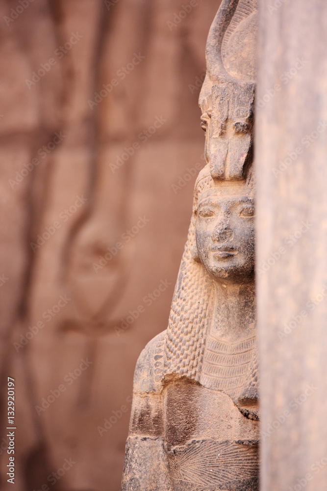 Φωτογραφία Ancient Egyptian goddess Isis and Ankh the ancient symbol of life, carved into an ancient temple wall in the background
