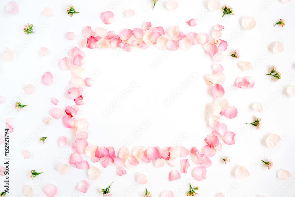 Frame made of pink roses petals on white background. Flat lay, top view. Valentine's background