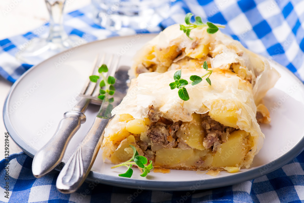 strudel with potatoes and forcemeat. .selective focus. strudel with potatoes and forcemeat. .selective focus.