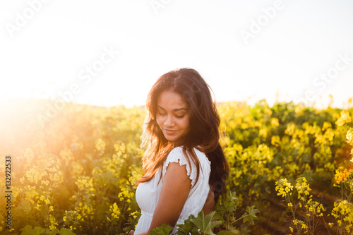 Young girl in yellow flower field