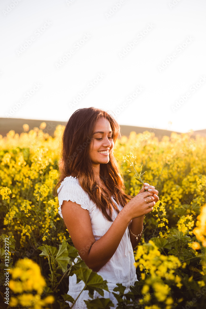 Young girl in yellow flower field Young girl in yellow flower field