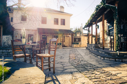 Small traditional paved square with cafe and authentic narrow streets in Nissaki  Ioannina  Greece