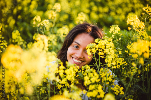 Young girl in yellow flower field