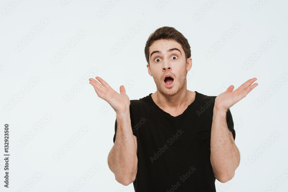 Confused man standing over white background. Confused man standing over white background.