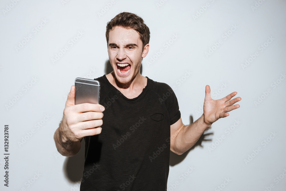 Angry man using phone. Angry man using phone.