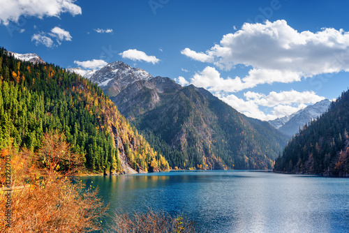 Beautiful view of the Long Lake among fall woods and mountains