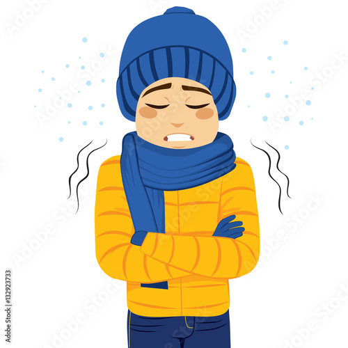 Young man freezing wearing winter clothes shivering