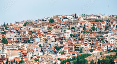 Aerial panoramic view of the colorful Thessaloniki city. Houses with red tile roofs are arranged in row on a hill. Greece © bortnikau