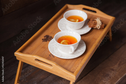 Herb tea with spice and lemon for two person. Selective focus