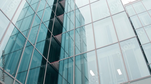 Close-up low angle shot of modern glass facade office building in Paris