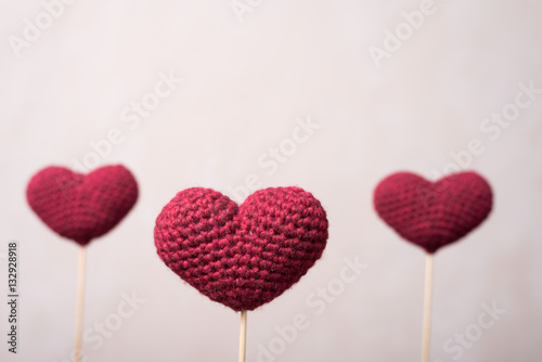 Three crocheted hearts on wooden sticks