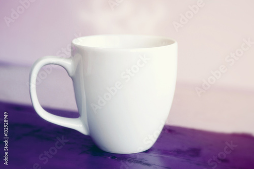 white cup on purple wooden table