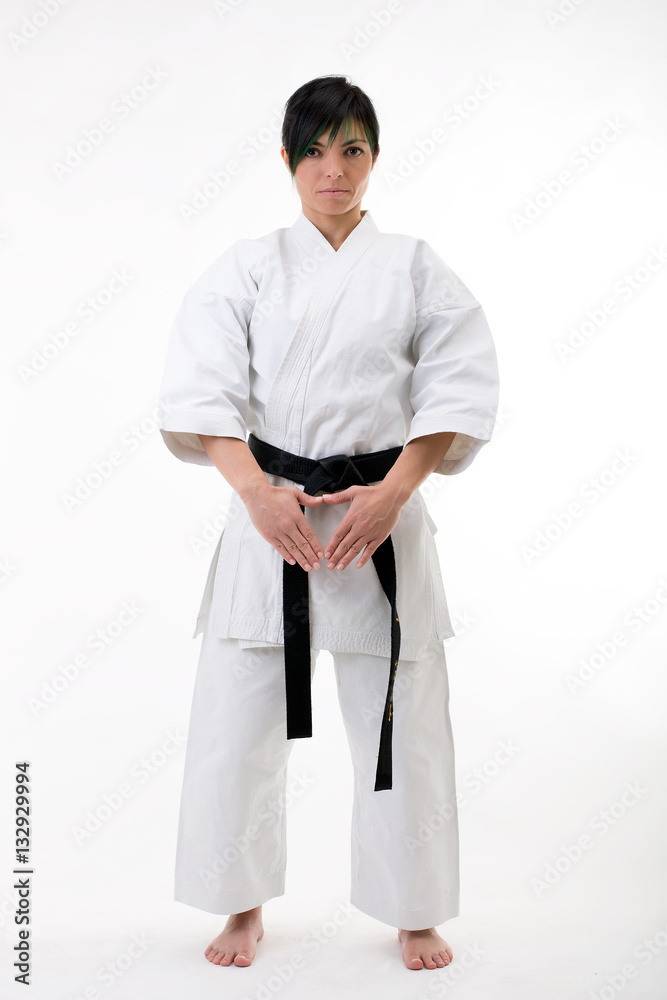 Young black belt fighter training Karate. Isolated woman portrait on white background Young black belt fighter training Karate. Isolated woman portrait on white background
