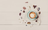 Autumn cappuccino coffee cup on white wood background