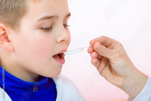 Little boy drinking syrup medicine liquid