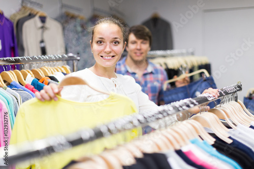 pair chooses clothes at the store