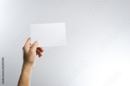 Hand hold blank photo paper card