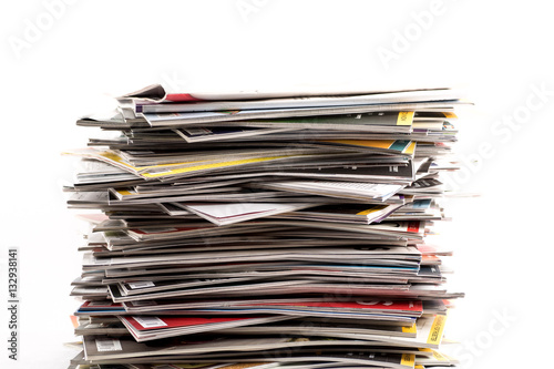Stack or pile of old subscription magazines against white background.  