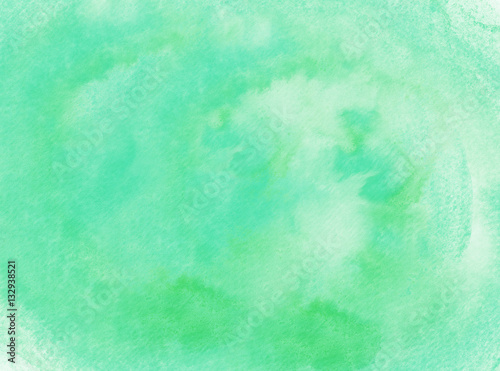 Abstract hand drawn watercolor background on textured paper in green shades