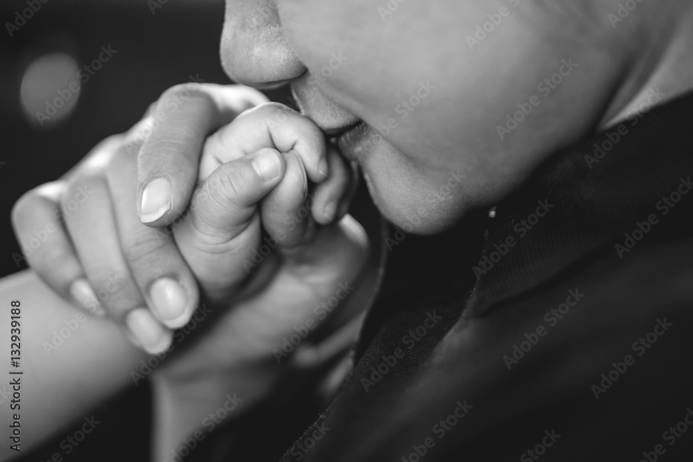 A year old Asian baby holding hand with his mother