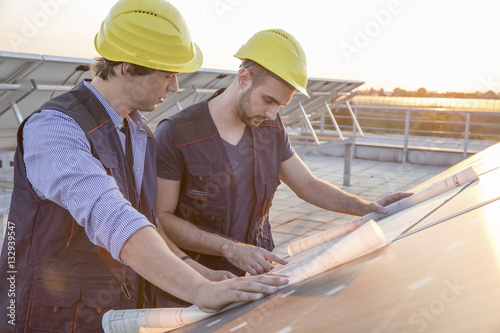 Architect and engineer inspecting solar power station