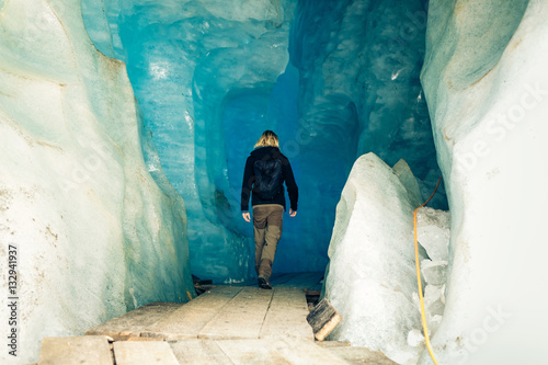 Young Man Hiking Through Glacier Cave © nullplus