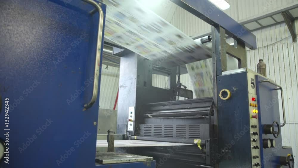 Color printing of newspapers on press in printing house, close up. Color printing of newspapers on press in printing house, close up.
