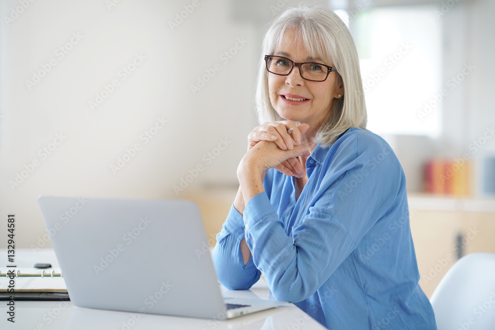 Senior businesswoman working in office Senior businesswoman working in office