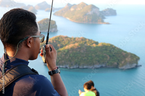 Rescue use radio to secure the tourists on the mountain at ang thong archipelago island, Thailand. May 5, 2016. 