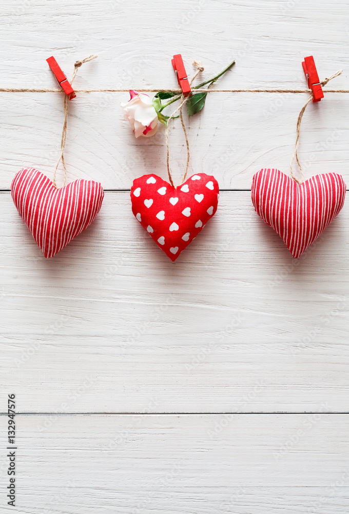 Fototapeta premium Valentine day background, pillow hearts border on wood