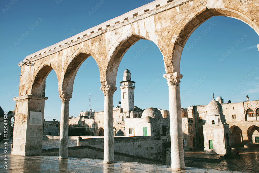 Scenery of old town of Jerusalem with arches and a mosque
